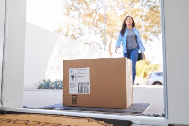 Woman Coming Back To Home Delivery In Cardboard Box Outside Front Door Technician explaining TV repair issue to customer after inspection at home